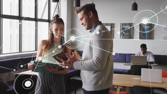 Woman holding folder man tapping tablet sparking network linking folder tablet for design review