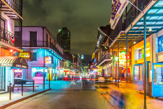 people on the move in the Burbon street at night in the French quarter