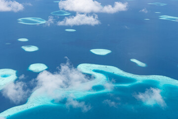 Stunning aerial landscape of Maldives coral reef system in deep blue ocean bay for summer travel...