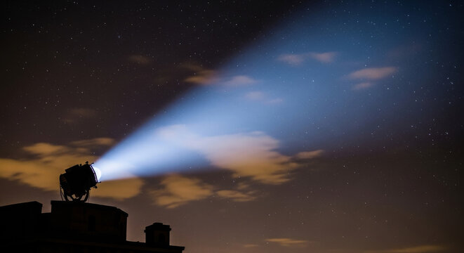 Powerful Searchlight Beam Illuminates Night Sky