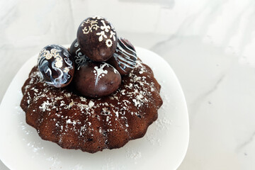 chocolate bundt cake with decorated easter eggs on plate