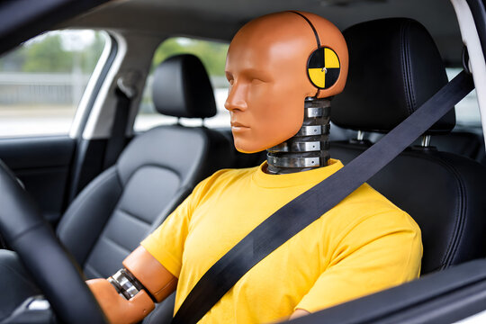 Crash test dummy wearing seatbelt inside car vehicle safety experiment concept automotive protection system collision impact research transportation engineering crash simulation laboratory testing roa