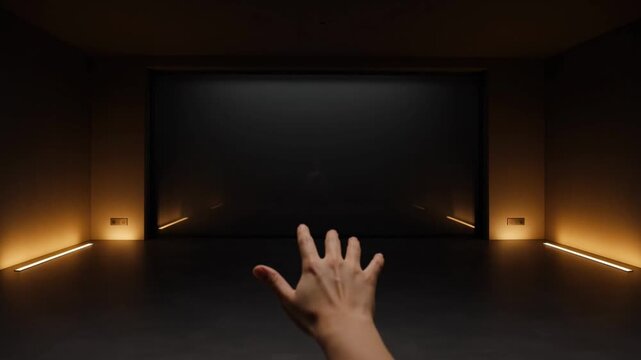 Interactive hand gesture control in futuristic dark room with glowing lights and screen