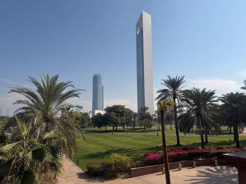 Abu Dhabi, UAE - January 11, 2026. Scenic park view with palm trees and modern skyscrapers. Abu Dhabi city skyline with ADNOC tower