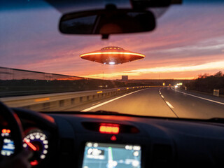 Passenger Looks Through Windshield As Mysterious Spaceship Appears Amidst Sunset Sky And Highway © Artoym