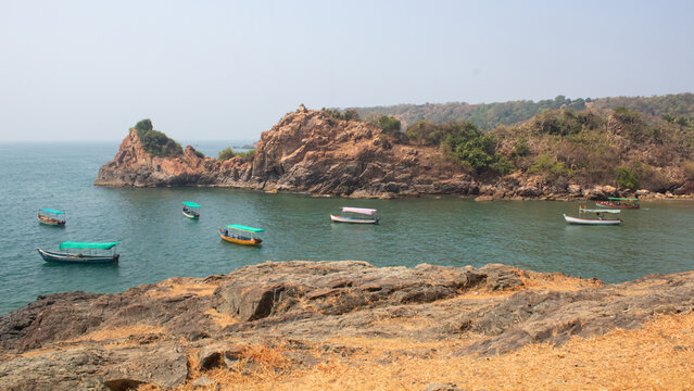 Multiple Small Boats Anchored in Calm Turquoise Bay, Golden Rock, Nivti Beach in Maharashtra, India