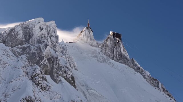 Snowy Aiguille du Midi peaks wind swept in Chamonix France