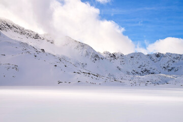 Wide view of snow-covered mountain slope with dramatic light and shadow, High Tatras, Five Lakes Valley, Dolina Pięciu Stawów, Poland © Urszula Piechota 