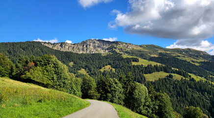 Fototapeta premium Route du Col du Pre winding through French Alps landscape, Beaufort, Savoie, France, Europe.