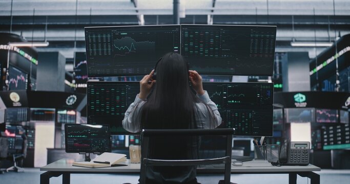 Woman Trader Start Online Stock Market Analysis. Female Broker Sits Desk With Coffee, Puts on Headset, Begins Work. Professional Digital Trading and Remote Financial Consultancy From Modern Office.