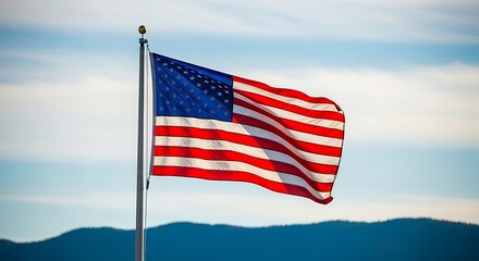 American flag waving in the wind with mountainous background
