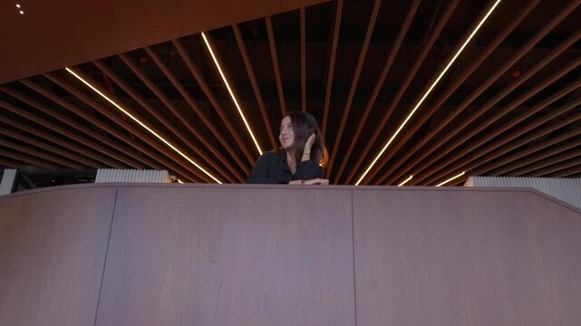 hispanic businessman standing on stairs. young woman in a black dress, woman in restaurant, woman figures walking in a modern hotels building interior, showcasing a sense of motion, activity,