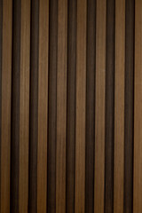 Fototapeta premium Texture of vertical dark brown wooden slats for modern interior wall paneling and architectural background
