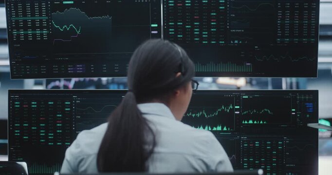 Professional Asian Trader Operates in Vast, Innovative Stock Exchange Hub. Concept of Future of Finance, Digital Transformation and Professional Female Leadership in High Tech Financial Sector.
