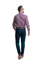 Rear view of stylish man walking away