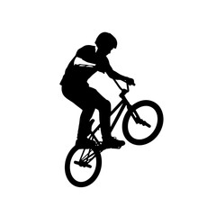 Naklejka premium Silhouette of a cyclist performing a BMX stunt midair on a street park.