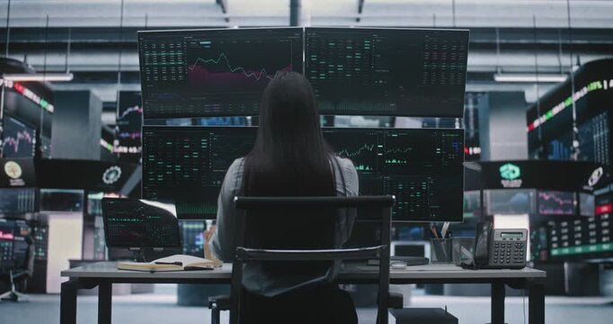 Young Asian Lady Sits Down With Cup, Securing Microphone Headset Engage on Stock Exchange Operations. Concept of Global Market Connectivity and Routine of Modern Financial Expert in Modern Workplace.