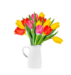 Obraz premium A bright bouquet of red, yellow, and pink tulips, elegantly arranged in a delicate white ceramic jug. Isolated on a white background.