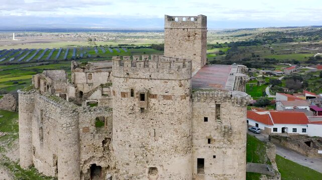 Aerial view of Belv&iacute;s de Monroy Castle, a medieval hilltop fortress ruins overlooking rural Caceres landscape, historic defensive architecture surrounded by countryside and open skies.