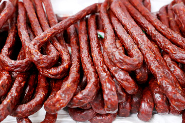 Close up of traditional hungarian homemade sausage aka kolbasz on farmers market for sale. Group of traditional hungarian sausages