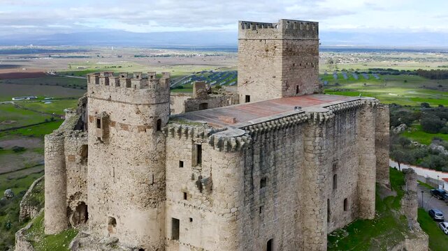 Aerial view of Belv&iacute;s de Monroy Castle, a medieval hilltop fortress ruins overlooking rural Caceres landscape, historic defensive architecture surrounded by countryside and open skies.