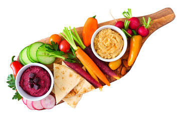 Assortment of fresh vegetables and hummus dip on a serving board. Top view isolated on a white...
