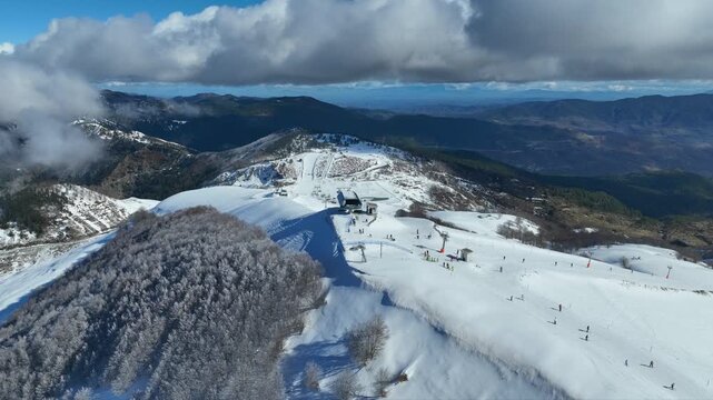 Aerial drone cinematic video of recently renovated snow center of Anilio Perched on the top of Pindus, with the comparative advantage of easy and direct access via the Egnatia Motorway, covered in sno