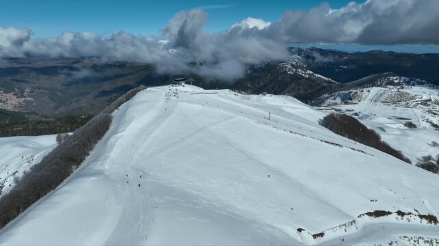 Aerial drone cinematic video of recently renovated snow center of Anilio Perched on the top of Pindus, with the comparative advantage of easy and direct access via the Egnatia Motorway, covered in sno