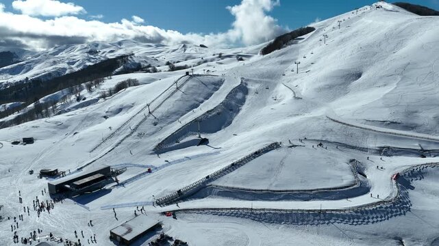 Aerial drone cinematic video of recently renovated snow center of Anilio Perched on the top of Pindus, with the comparative advantage of easy and direct access via the Egnatia Motorway, covered in sno