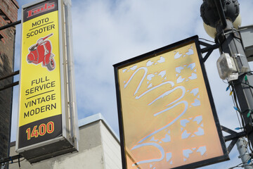 Obraz premium projecting sign outside Fada Motorrad/scooter, a motorcycle dealer, located at 1410 Gerrard St E, Toronto (Gerrard India Bazaar BIA panel by Reesha and Alpesh)