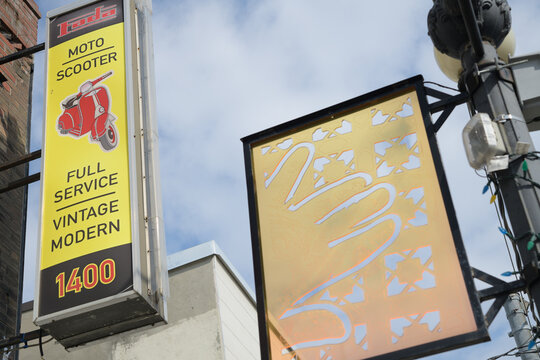 projecting sign outside Fada Motorrad/scooter, a motorcycle dealer, located at 1410 Gerrard St E, Toronto (Gerrard India Bazaar BIA panel by Reesha and Alpesh)