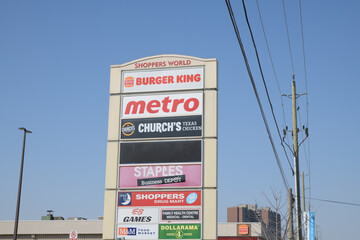 Obraz premium pylon road sign at Shoppers World Danforth with business directory (Metro supermarket is located there at 3003 Danforth Av and Victoria Park Av), Toronto