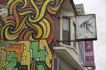 Obraz premium fancy mural on the (west facing) exterior wall of 620 Gerrard St E, Toronto (with projecting ghost sign featuring a fish)