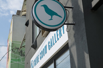Obraz premium round projecting sign outside Blue Crow Gallery located at 1330 Gerrard St E, Toronto