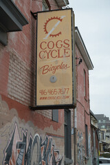 Naklejka premium exterior projecting sign of Cogs Cycle located at 1 Howland Rd, on Gerrard St E, Toronto