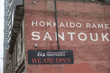Naklejka premium exterior building wall with signage outside Hokkaido Ramen Santouka located at 91 Dundas St E, Toronto