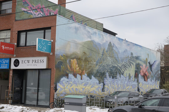 exterior building facade mural and sign of ECW Press Ltd, a book publisher, located at 665 Gerrard St E, Toronto