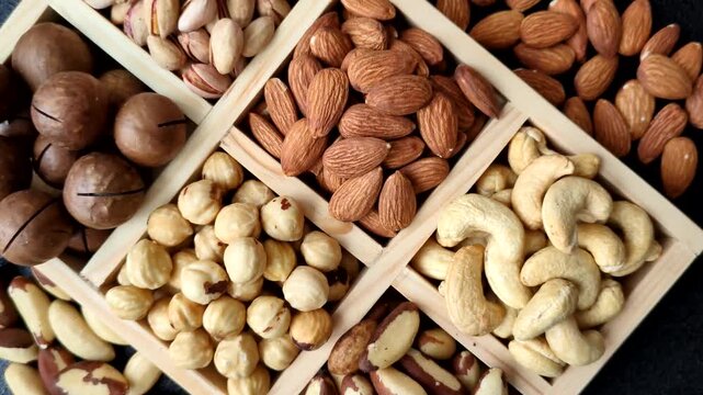 A mix of cashews, pistachios, almonds, brazil nuts, macadamia and hazelnuts as healthy food ingredients. Nuts as a food background for your design