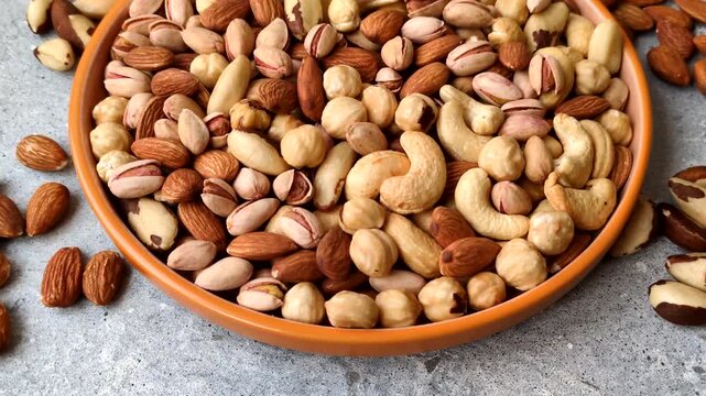 A mix of cashews, pistachios, almonds, brazil nuts, macadamia and hazelnuts as healthy food ingredients. Nuts as a food background for your design