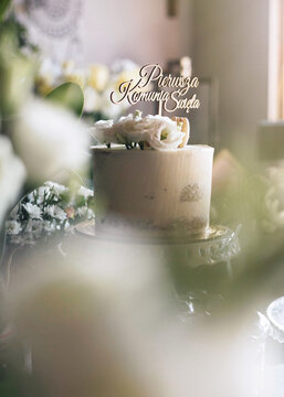 Simple, elegant cake with "Pierwsza Komunia Święta" cake topper - "first communion" in Polish