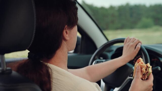 woman girl eating burger car, happy person, Woman eating burger while driving a car, Enjoying fast food on the go, Safe driving with snack, Lunch break in the car, Modern lifestyle image, Quick bite