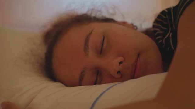 Serene woman resting peacefully. Bicultural woman gently relaxing in peaceful hotel room atmosphere. Woman of mixed heritage finds serene comfort during quiet afternoon break in cozy hotel suite