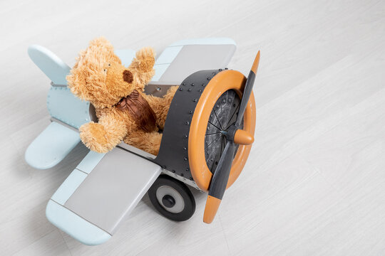 teddy bear and wooden toy airplane with world map, Travel concept. party decoration.children's toys happy birthday day. copy space. Commitment and creative growth concept