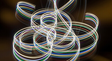 Colorful Abstract Light Trails Swirling and Intertwining Against a Dark Background