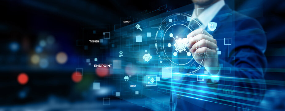 Businessman pointing at API integration technology on futuristic digital interface screen, application programming interface, cloud connectivity, software development concept