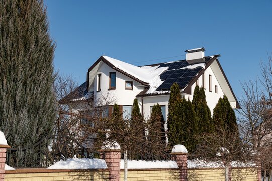 Winter setting with solar panels on a house showing safety features and autonomy
