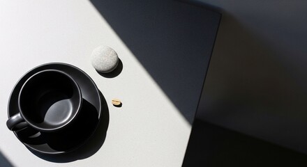 Minimalist Still Life with Black Ceramic Coffee Cup, Pebble, and Green Coffee Bean