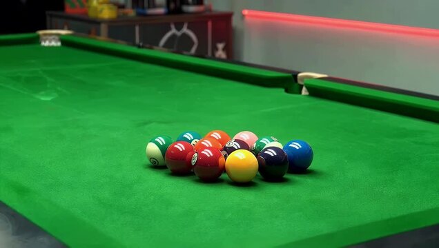 Crisp 4K close up footage of colorful billiard balls perfectly arranged on green pool table inside game room capturing leisure atmosphere symmetry classic indoor 