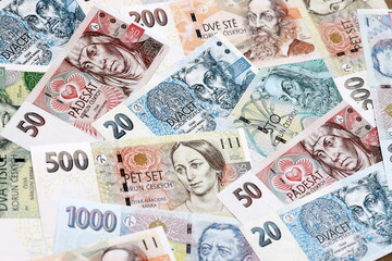 Obraz premium Czech koruna money bills pile on table. Czech Republic banknotes of CZK currency close up.