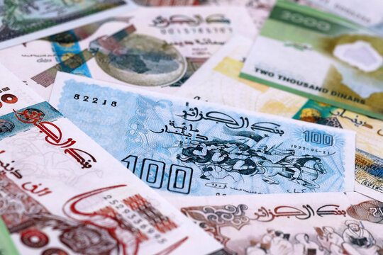 Algerian dinar money bills pile on table. Algeria banknotes of DZD currency close up.